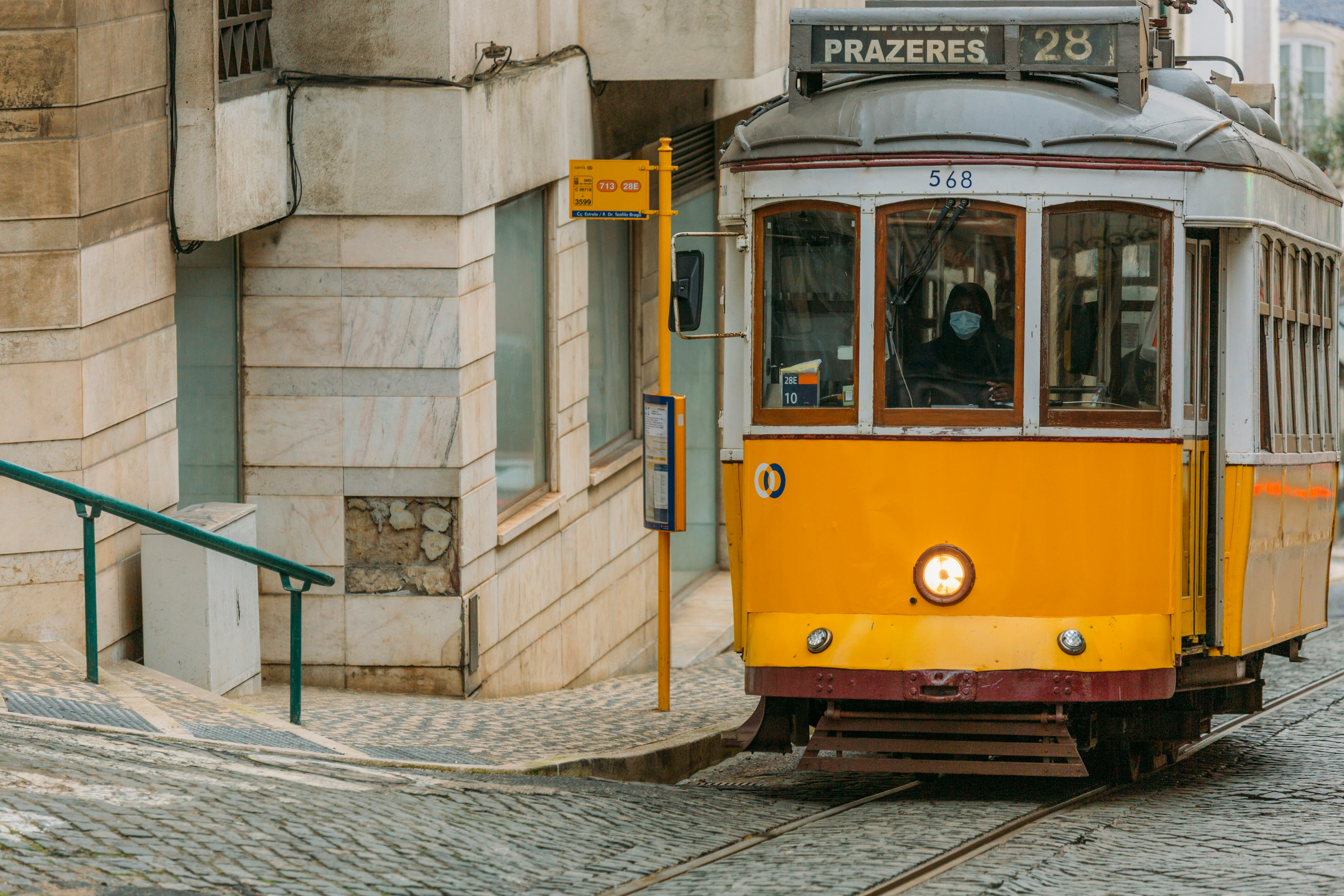 yellow and white tram on road during daytime